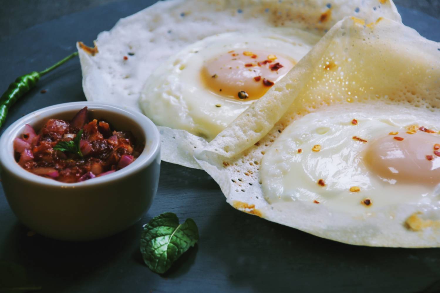 Homemade Egg Hopper or Bittara Appa / Sri Lankan breakfast Appam with boiled egg in the center